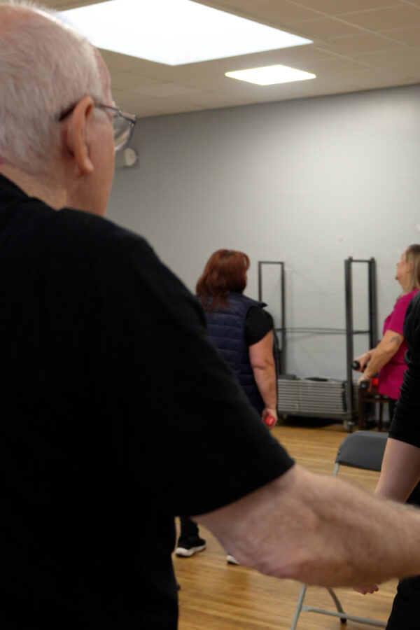 Active Lifestyles worker smiling instructing an exercise class