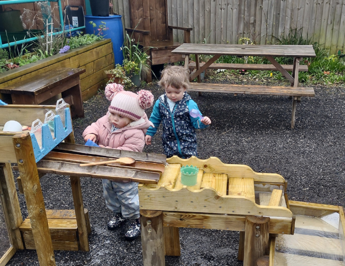 Young children playing with the water play at Irlam Library