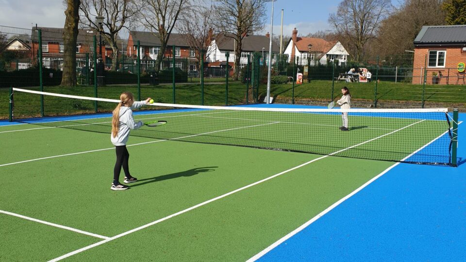 Children playing tennis in salford