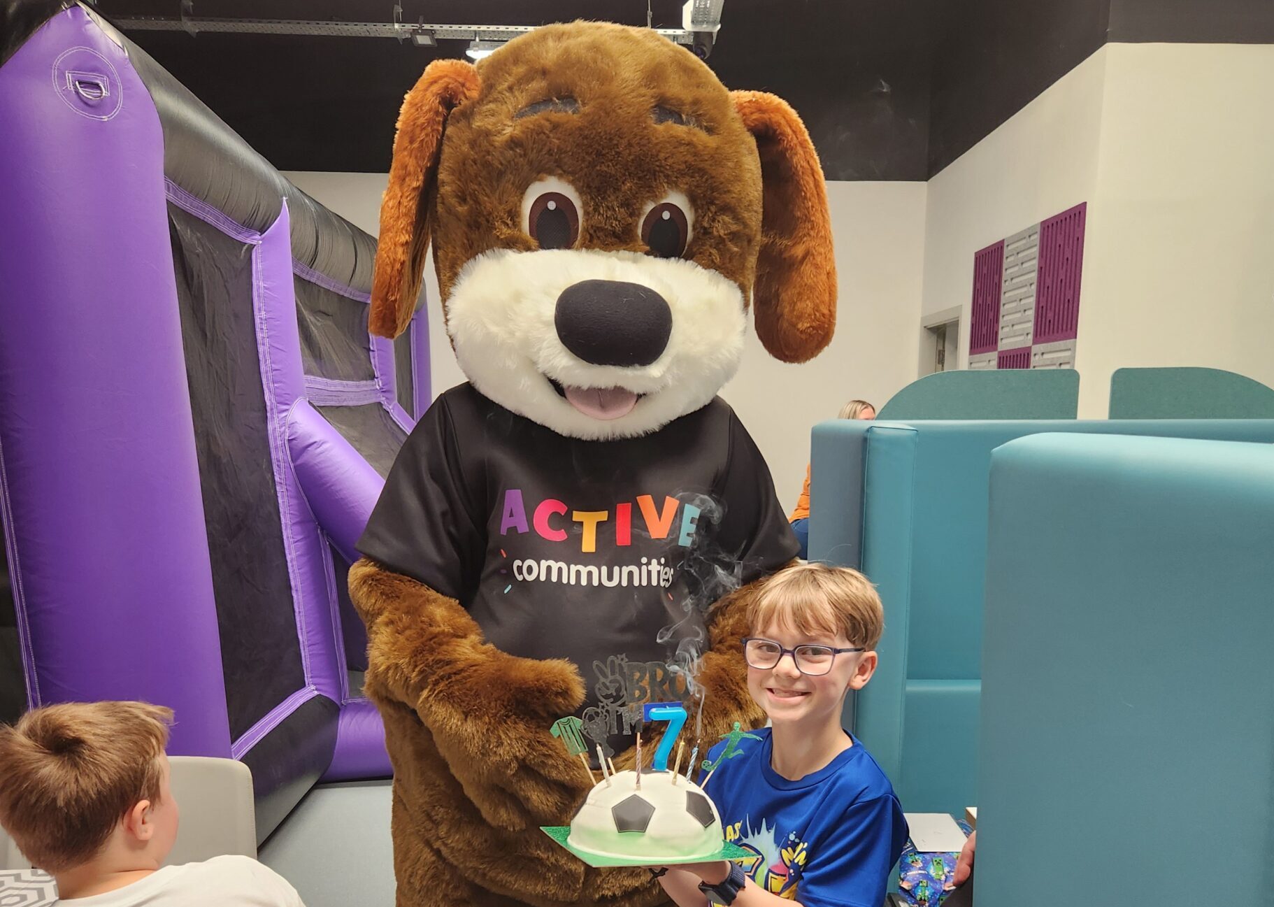 A child with a birthday cake at a birthday party at the den