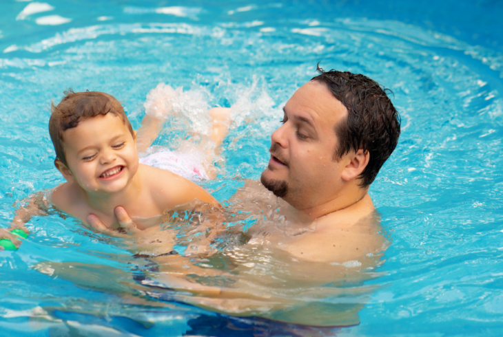 Man and child in pool