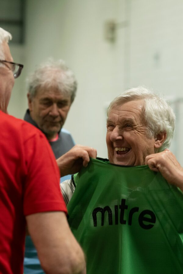 Older gentleman enjoying a Sporting Memories session