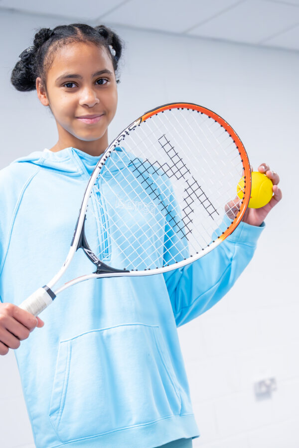Girl with tennis racquet and ball