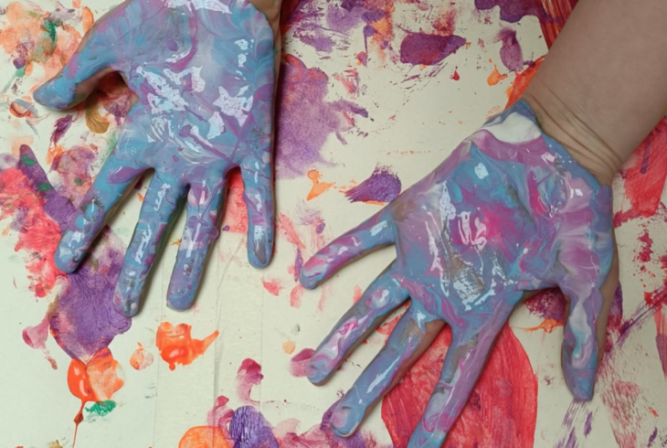 Hands covered in paint