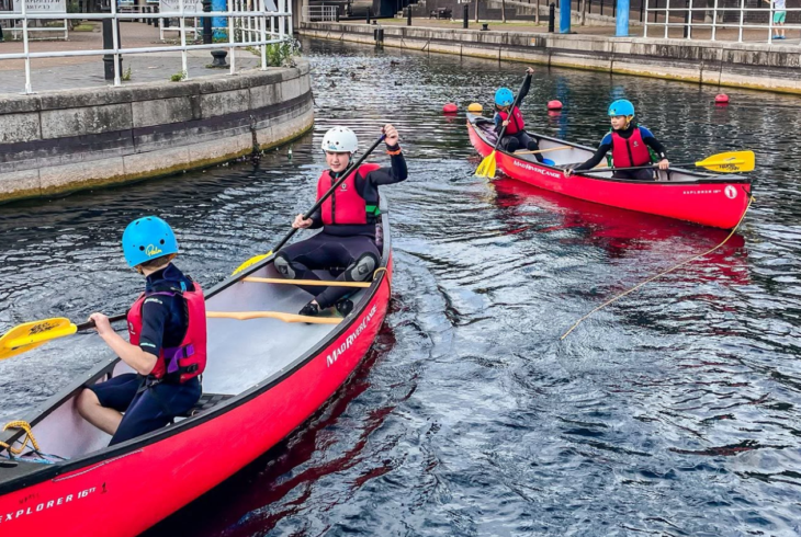 Young people in canoes